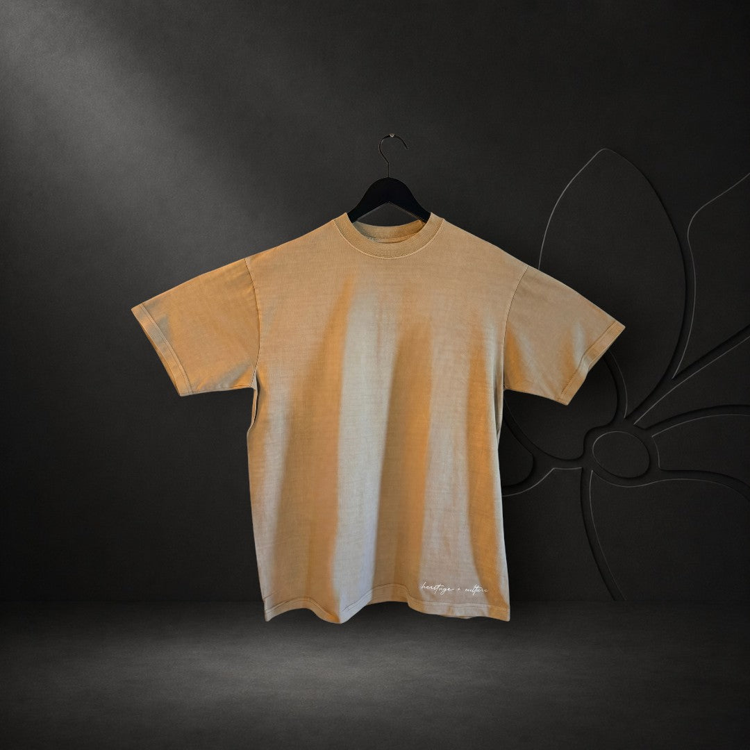 KA'EO Apparel vintage bone oversized heavyweight t-shirt with white Heritage + Culture embroidery on the hem.