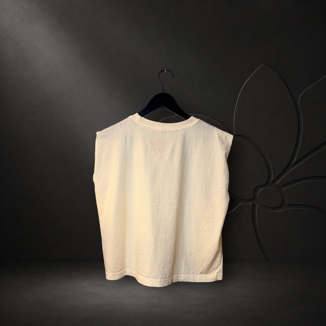 KA'EO Apparel cream crew neck muscle tank top with a relaxed fit and sleeveless design on a black hanger