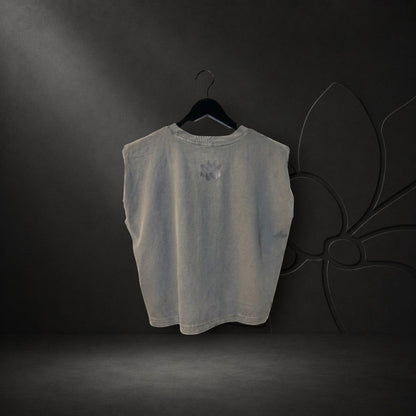 KA'EO Apparel women's faded black crew neck muscle tank top with a small sampaguita logo on the back, hanging on a hanger.