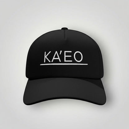 Black KA'EO Apparel snapback cap with white embroidered logo and underline detail. Structured brim, mid-profile fit.