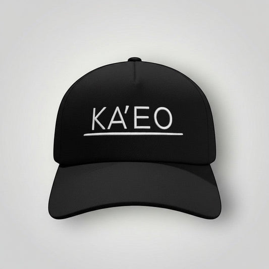 Black KA'EO Apparel snapback cap with white embroidered logo and underline detail. Structured brim, mid-profile fit.