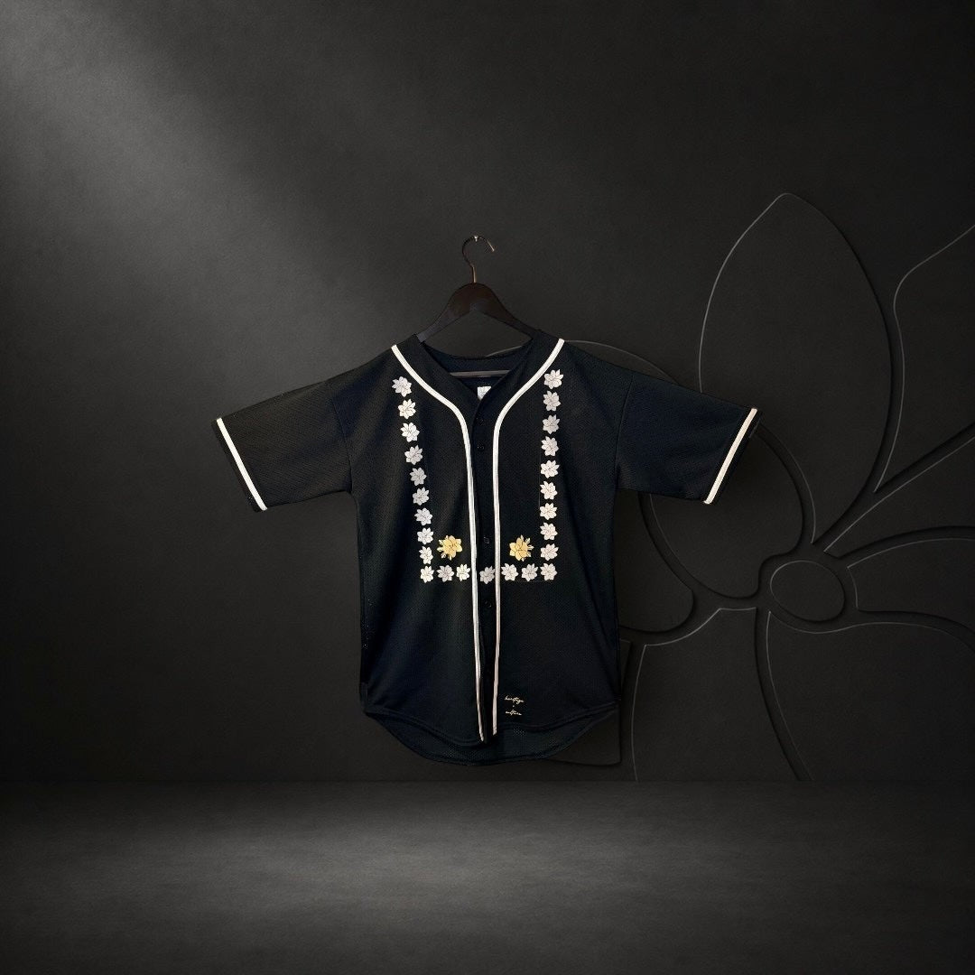 KA'EO Apparel black mesh baseball jersey featuring white piping and intricate Sampaguita floral embroidery on the front.