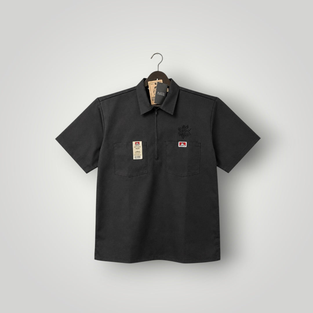 KA'EO Apparel black poly-cotton twill short sleeve work shirt with quarter-zip and two chest pockets.