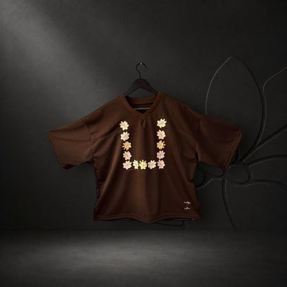 KA'EO Apparel brown mesh cropped football jersey with a Sampaguita flower graphic in a U-shape design.