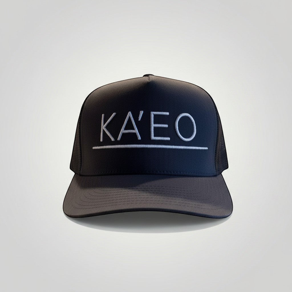 KA'EO Apparel dark grey trucker hat with white embroidered logo and mesh back panels.