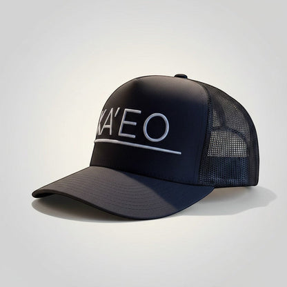 KA'EO Apparel dark grey trucker hat with white embroidered logo and mesh back panels.