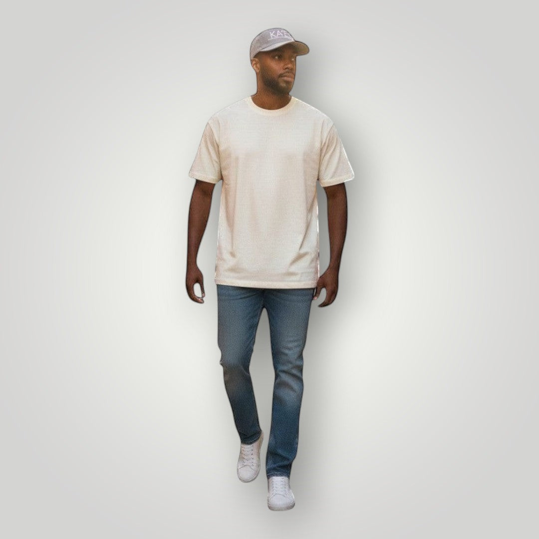 KA'EO Apparel gray embroidered snapback cap worn by a man walking on a cobblestone street.