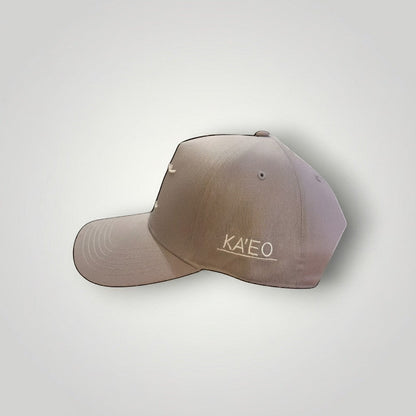 KA'EO Apparel gray cotton snapback cap with embroidered 'heritage + culture' script and side branding.
