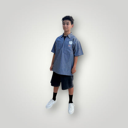 KA'EO Apparel grey pinstripe short-sleeve butcher shirt with quarter-zip and floral embroidery.