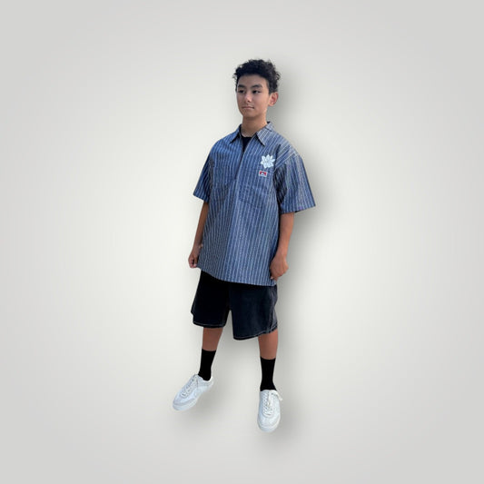 KA'EO Apparel grey pinstripe short-sleeve butcher shirt with quarter-zip and floral embroidery.