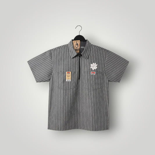 KA'EO Apparel grey pinstripe short-sleeve butcher shirt with quarter-zip, two chest pockets, and floral embroidery.