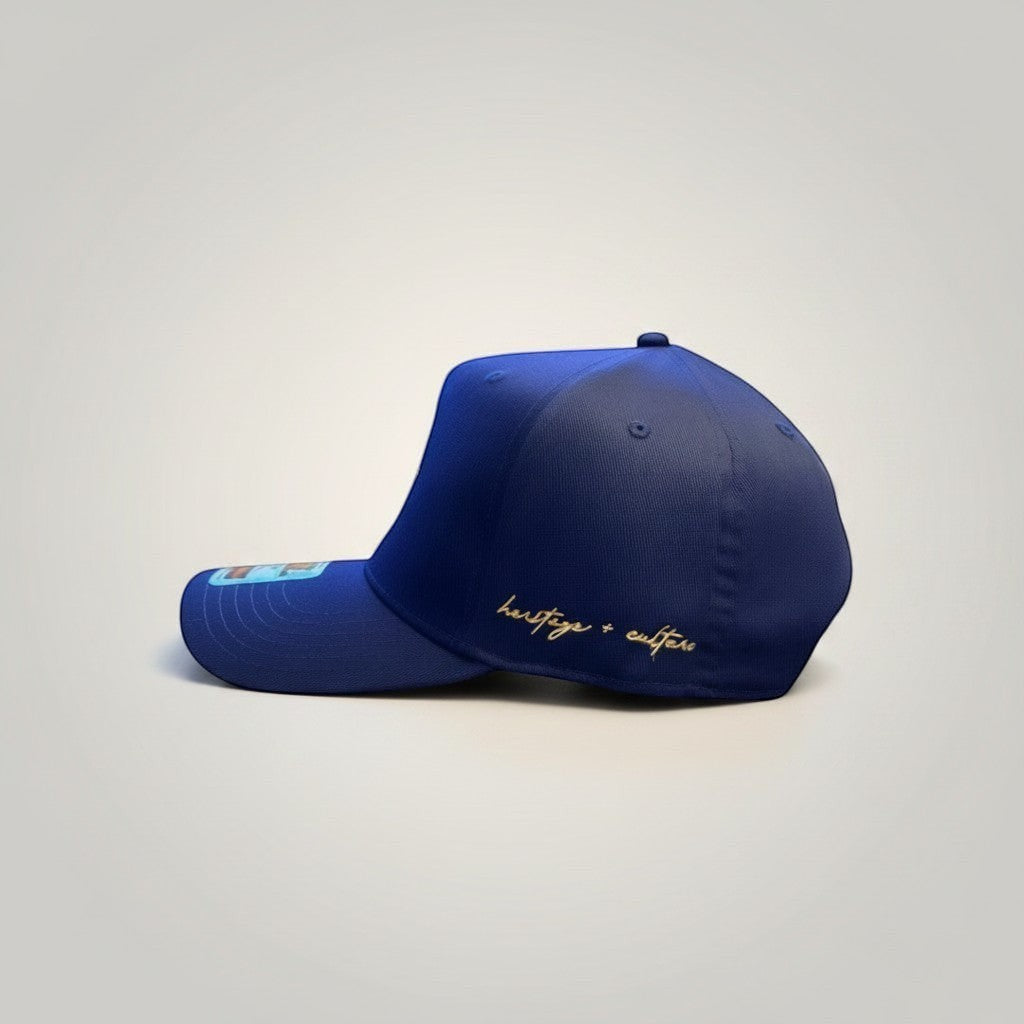KA'EO Apparel Navy Embroidered Sampa-Sol Snapback with gold "heritage + culture" script on side.